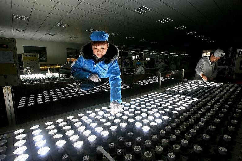 Chinese employees at a lighting factory. China led the way in what was a strong quarter for the world's manufacturers, with its official manufacturing index expanding at the fastest pace in nearly five years. Higher commodities prices and global dema