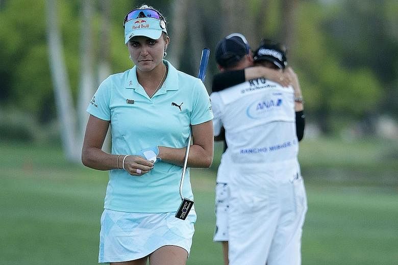 A heartbroken Lexi Thompson walking off the 18th green, as Ryu So Yeon celebrates her second Major title with her caddie after winning the first play-off hole at Mission Hills Country Club.