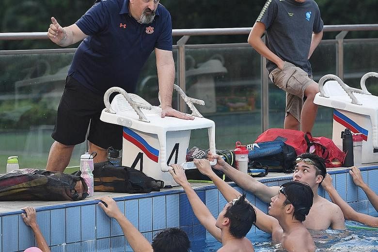 Former national coach Sergio Lopez directing proceedings at a clinic at St Joseph's Institution International yesterday. He encourages parents to view swimming as a way for their children to pick up life skills such as discipline and tenacity and not