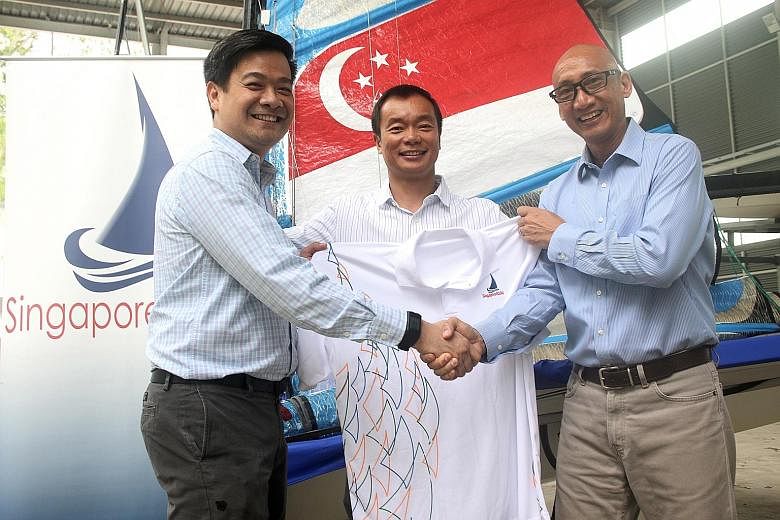 Lim Han Ee (left) took over from Andrew Tam (right) at the helm of SingaporeSailing yesterday. With them is the association's president Ben Tan.