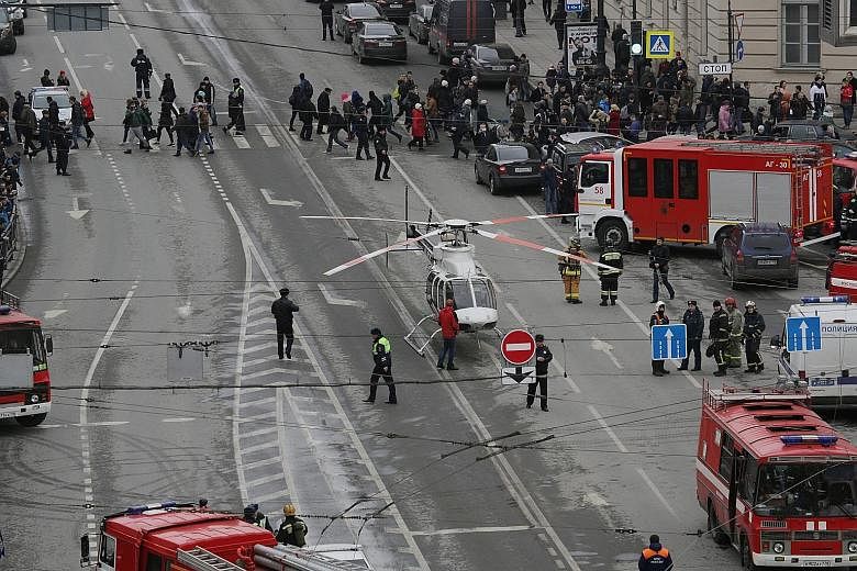 Emergency vehicles and workers outside the Sennaya Square station in St Petersburg after the blast yesterday. While one official said the blast showed all the signs of a terror attack, President Vladimir Putin said it was too early to speak about the