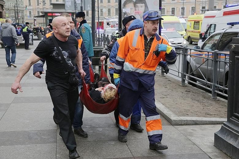 Emergency vehicles and workers outside the Sennaya Square station in St Petersburg after the blast yesterday. While one official said the blast showed all the signs of a terror attack, President Vladimir Putin said it was too early to speak about the
