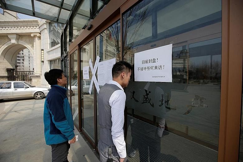 A "closed" sign at a real estate office yesterday as the Chinese government bans new property sales in counties earmarked as part of a new special economic zone in Xiongan, Hebei province.