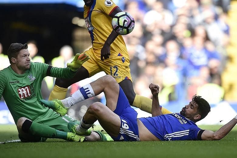 Chelsea's Diego Costa getting stuck in against Palace goalkeeper Wayne Hennessey in the Blues' shock 1-2 loss on Saturday. The Brazil-born Spain forward wants to reignite his earlier dominant form, having scored 13 league goals until Christmas but on