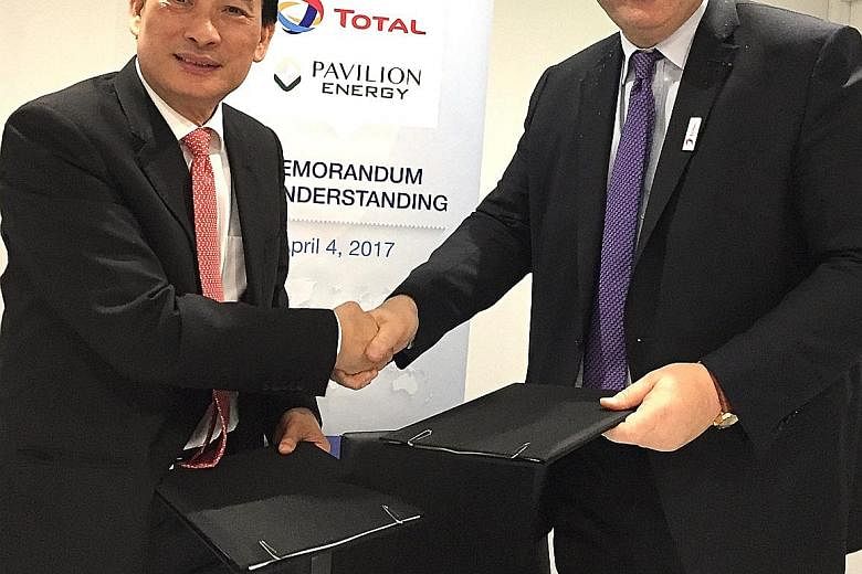 Mr Seah Moon Ming, CEO of Pavilion Energy and Pavilion Gas, and Mr Patrick Pouyanne, chairman and CEO of Total, at the signing ceremony yesterday.