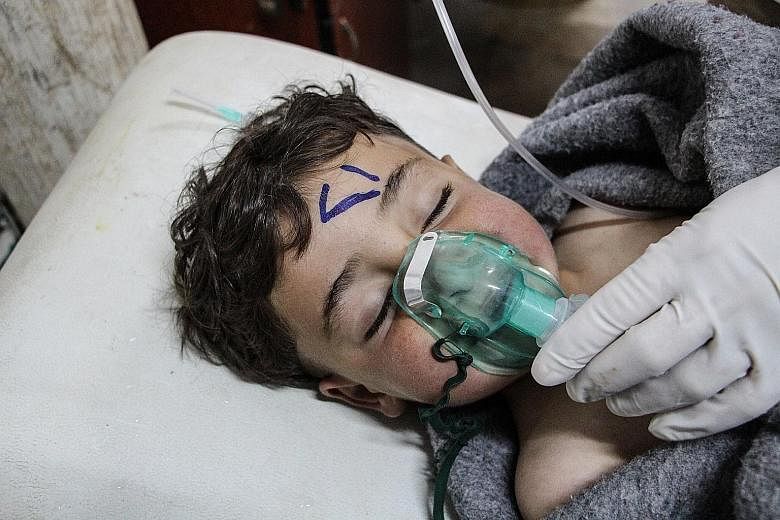 A Syrian child being treated at a field hospital in Saraqib, Idlib province, after an alleged chemical attack. The latest violence came as the EU and UN hosted a conference in Brussels on Syria.