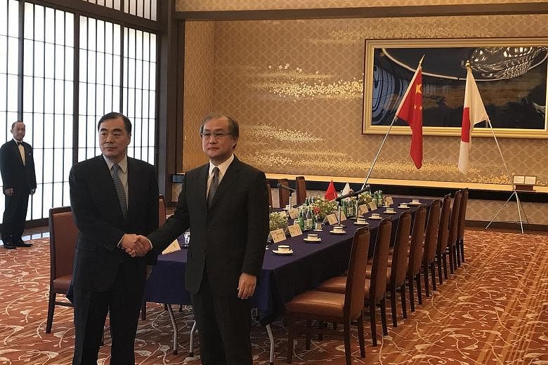 Mr Kong Xuanyou (left) and Mr Takeo Akiba discussed the North Korean nuclear and ballistic missile threat and the political situation in South Korea, among other things, during their meeting at the Iikura Guest House in Tokyo yesterday.