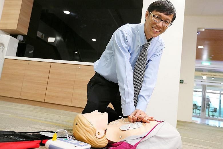 Prof Ong showing how to use an automated external defibrillator yesterday. He says Singapore still has some way to go in CPR training.