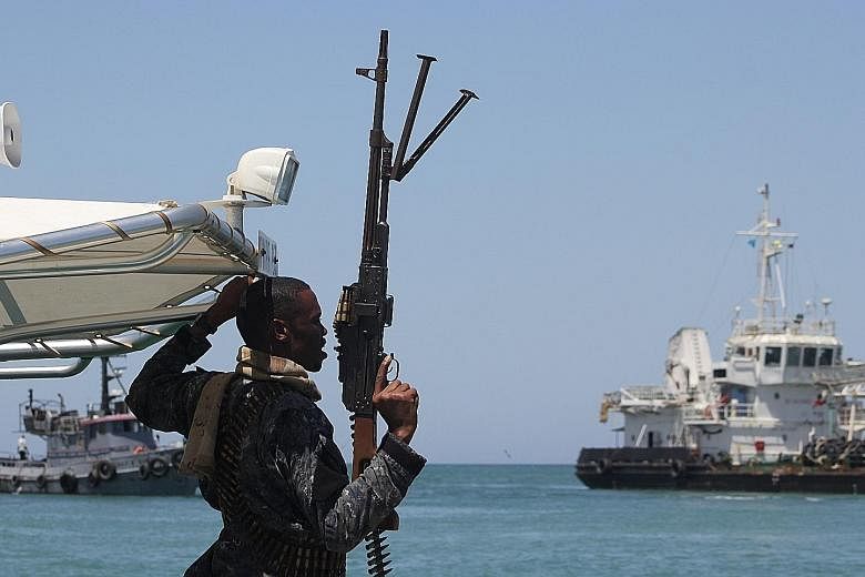 A maritime policeman on alert as an oil tanker released by Somali pirates sailed to Bosasso in Somalia's semi- autonomous region of Puntland last month.