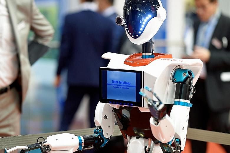 A robot at the Aircraft Interiors Expo 2017 in Hamburg, Germany, this week. A new report says the innovation in artificial intelligence, or AI, and robotics could force governments to order quotas of human workers, upend traditional working practices
