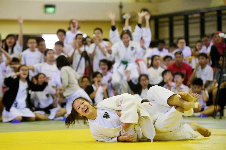 NYGH judoka Wang Jinghan scoring a waza-ari. She beat RGS' Yang Tongchen to help Nanyang win the Schools National B Division girls' title. 