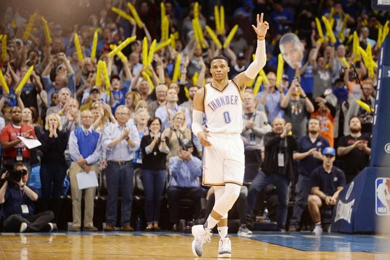 Thunder guard Russell Westbrook reacts as it is announced at Chesapeake Energy Arena that he has tied Oscar Robertson's NBA season triple-double record. His 41st triple-double of this campaign came against the Bucks, scoring 12 points, dishing out 13 assi