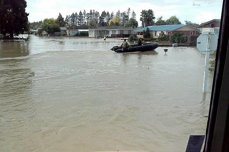 New Zealand Defence Force personnel at work in the flood-stricken town of Edgecumbe on the North Island yesterday. No deaths have been reported in New Zealand, but "there's still a risk of loss of life", Deputy Prime Minister Paula Bennett said amid 