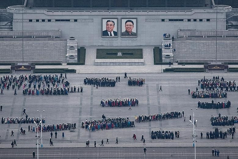 North Koreans preparing for an upcoming parade at Kim Il Sung Square, named after the country's founder, on Thursday. Pyongyang this week fired another missile and is said to be gearing up for a showcase of its prowess to mark the 105th anniversary o