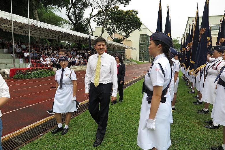 Minister for Education (Schools) Ng Chee Meng inspecting the GBS officers' contingent during their 90th anniversary parade yesterday.