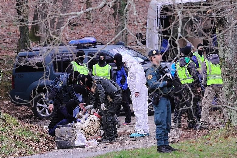 Spanish forces recovering explosives from a forest near the Spanish Basque city of Irun last month. The stash is believed to belong to the Basque separatist group ETA, which yesterday promised to completely disarm.