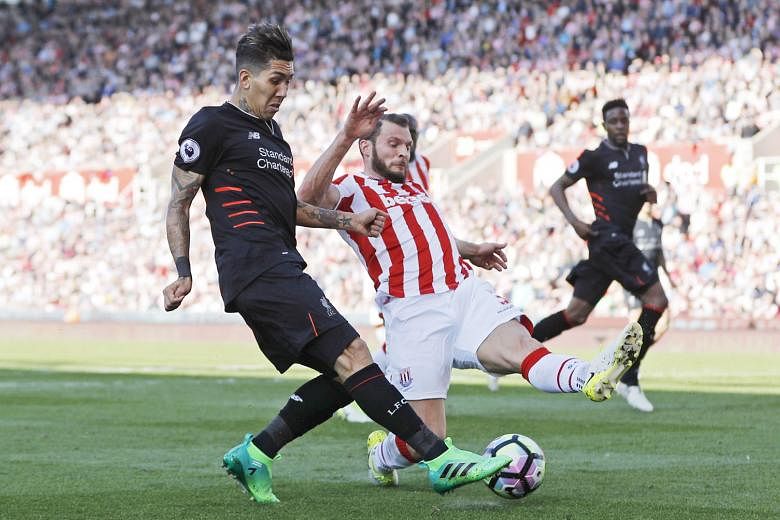 Liverpool's Roberto Firmino on the ball as Stoke's Erik Pieters challenges him. Firmino hit the winner after Philippe Coutinho equalised. 