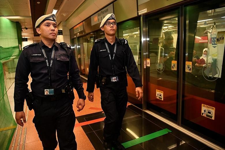 Staff Sergeant Nasron Nasir (far left) and Corporal Muhammad Ruzaini were the first TransCom officers to arrive at Hougang MRT station after an unattended bag was found on its platform.