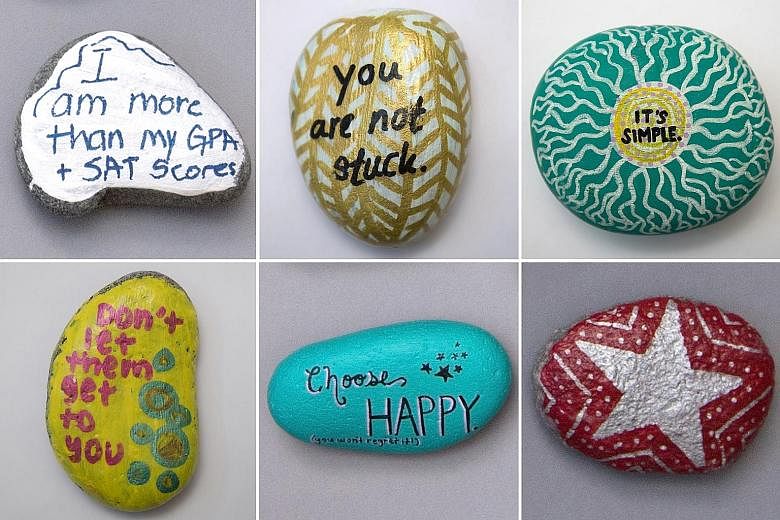 Some of the rocks painted by students at Lexington High School with messages meant to boost spirits and spread calm. The maxims became a visual reminder of a larger, community-wide initiative: to tackle the joy-killing, suicide-inducing performance a