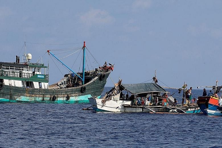 Filipino fishing boats alongside a Chinese vessel near Scarborough Shoal last Thursday.