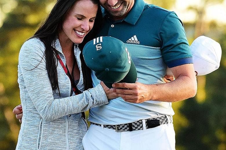 Sergio Garcia of Spain embraces fiancee Angela Akins after defeating Justin Rose to win his first Major. Akins, who will marry Garcia in July, left him a series of inspirational Post-It notes during the tournament.