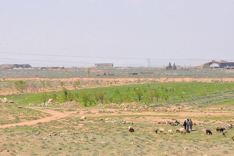 Syrian shepherds near the damaged Shayrat airfield, the Syrian government military base targeted last Thursday by US Tomahawk cruise missiles.