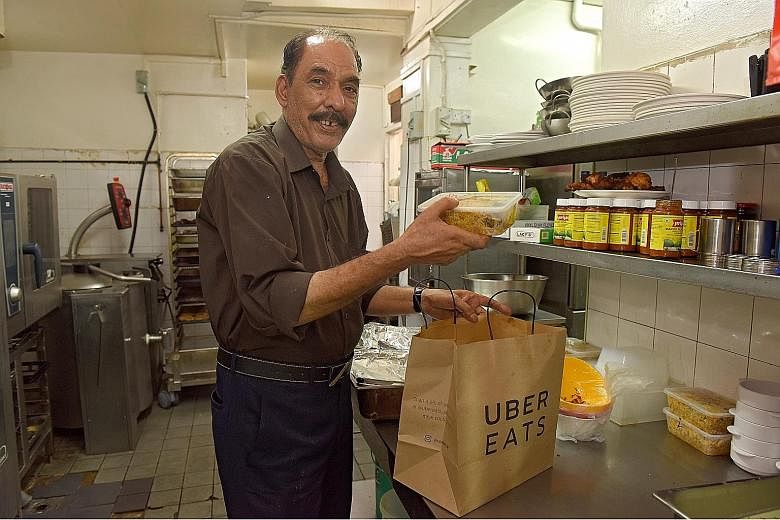 Mr Mohammad Rahim Dad Khan Abbasi, a chef at Bismillah Briyani Restaurant, packing food for delivery last Thursday. Since teaming up with food delivery platforms such as UberEats and Foodpanda last September, the restaurant's revenue has gone up 17 p