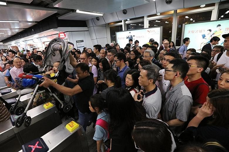 Passengers waiting at the Kwun Tong station after MTR services were disrupted on Monday.