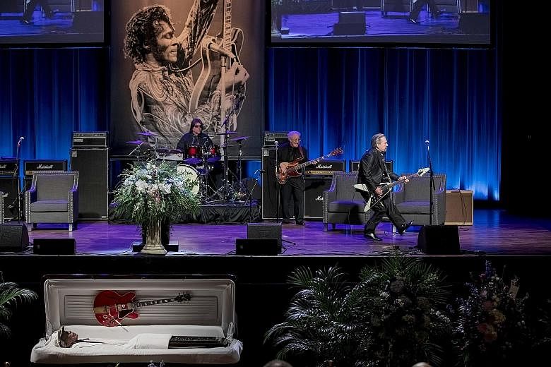 Musician Billy Peek (right) performing Johnny B. Goode during a memorial for Chuck Berry, who was laid out with his Gibson guitar in St Louis on Sunday.