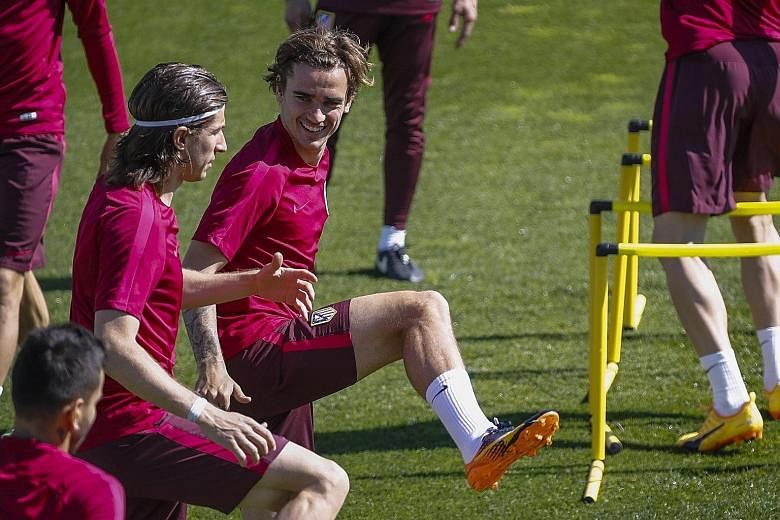 Atletico forward Antoine Griezmann (right) and defender Filipe Luis in training. The team may have to seize the initiative, being the home side.