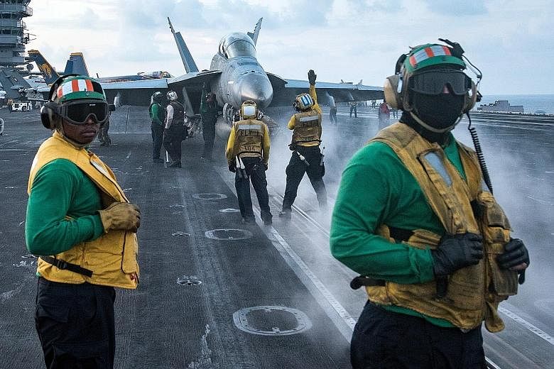 US sailors conducting flight operations on the aircraft carrier USS Carl Vinson in the South China Sea last Saturday. The ship's deployment to the waters off the Korean peninsula has raised tensions across East Asia.