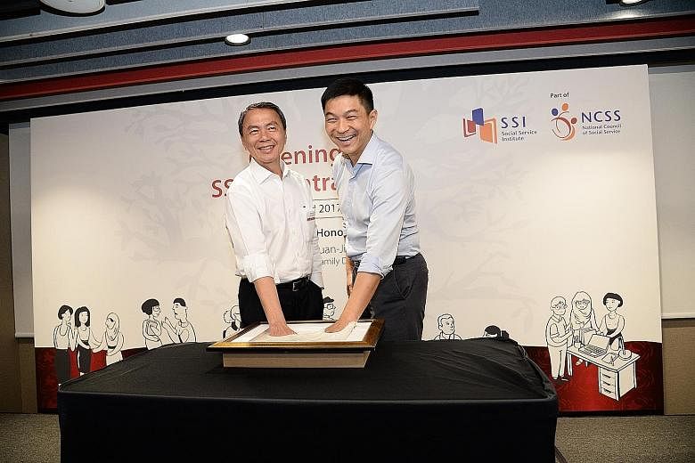 Minister Tan Chuan-Jin (right) is joined by NCSS president Hsieh Fu Hua for the hand-casting ceremony to mark the official opening of the Social Service Institute's new premises at Central Plaza in Tiong Bahru.