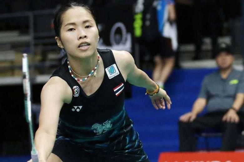 Above: Defending women's singles champion Ratchanok Intanon making an early first-round exit at the Singapore Open, with a 8-21, 18-21 loss to Japan's Sayaka Sato.