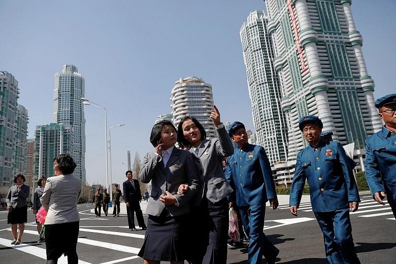 North Koreans checking out the newly opened Ryomyong Street development in Pyongyang yesterday. North Korean leader Kim Jong Un opened the prestige housing project in downtown Pyongyang yesterday, with tens of thousands of citizens looking on. Comple