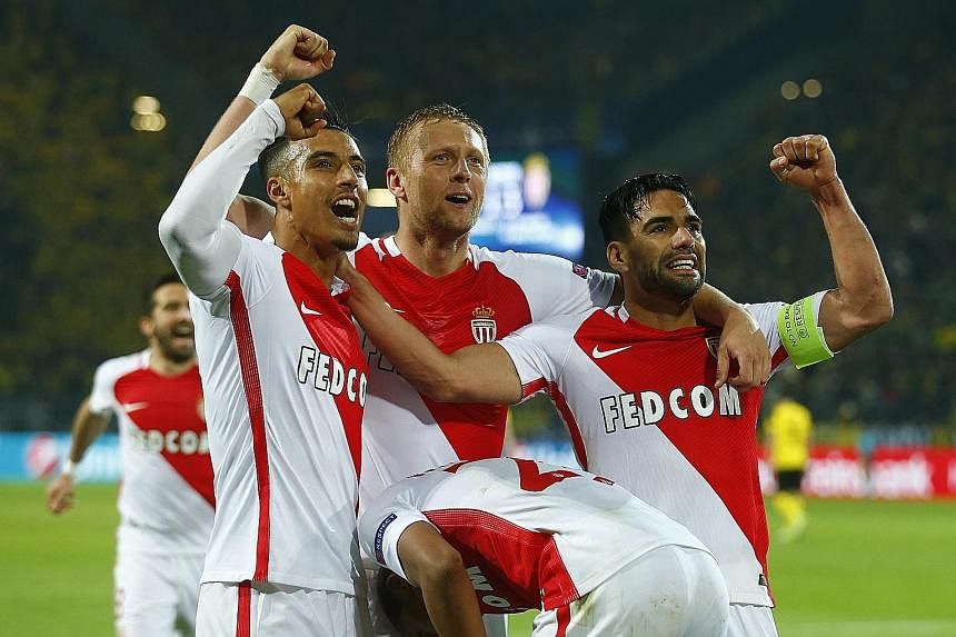 Above: Monaco captain Falcao leads the celebrations with his team-mates after the French side score their third away goal in Dortmund.