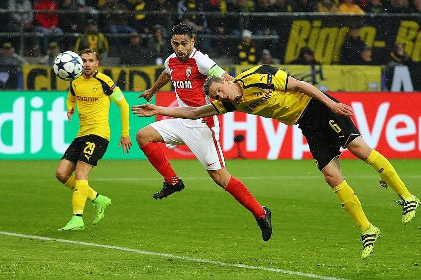 Above: A horror start for Dortmund, as Sven Bender's own goal while fending off Radamel Falcao puts Monaco 2-0 ahead in the 35th minute. 