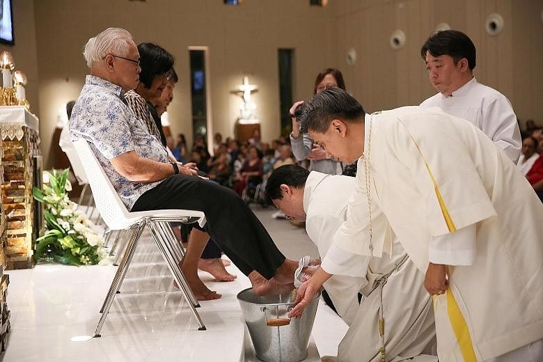 Father Joachim Chang washing the feet of 12 churchgoers in a Maundy Thursday tradition during Mass last night at Singapore's newest Catholic church, the Church of the Transfiguration, in Punggol. The deed was a re-enactment of biblical history, when 