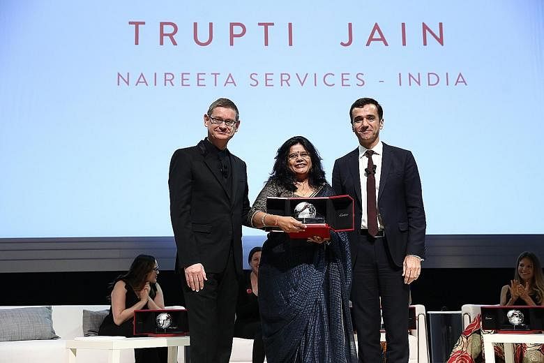 Naireeta Services founder Trupti Jain receiving her award from Cartier chief executive Cyrille Vigneron (left) and Insead dean Ilian Mihov at the Victoria Theatre and Concert Hall.