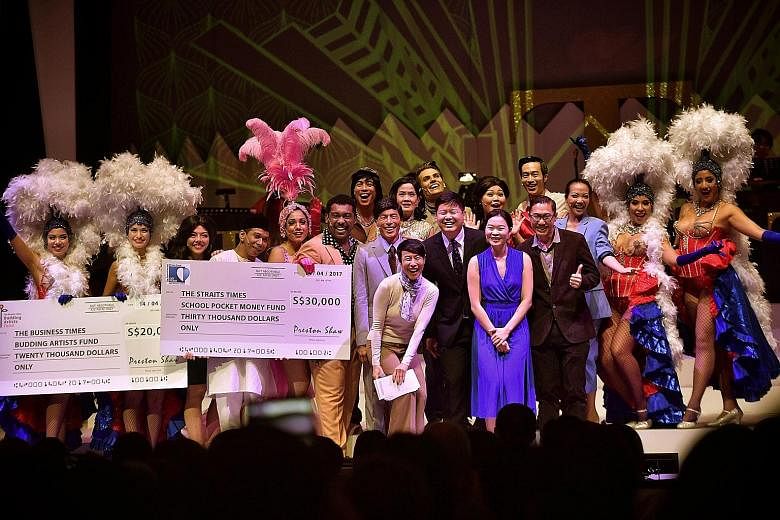 Mr Shaw Jia Hong (centre, in black) presented two cheques to two charities after the curtain call last night. With him are the musical's producer Tan Kheng Hua (next to him, wearing a scarf); ST managing editor Fiona Chan (in blue); Mr Tan Tee Tong (