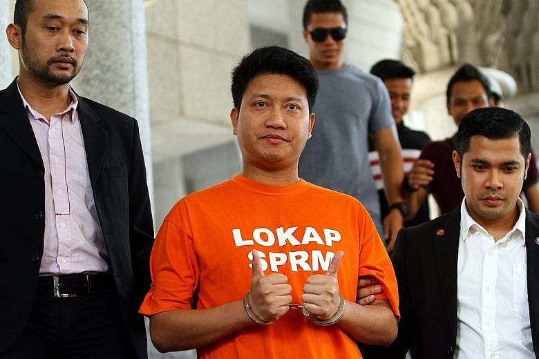 Parti Keadilan Rakyat's Ampang youth chief Adam Rosly arriving at the Ampang court complex yesterday. The Malaysian Anti-Corruption Commission was allowed to remand him for five days, until next Tuesday, to investigate him over his "unusual" wealth, 