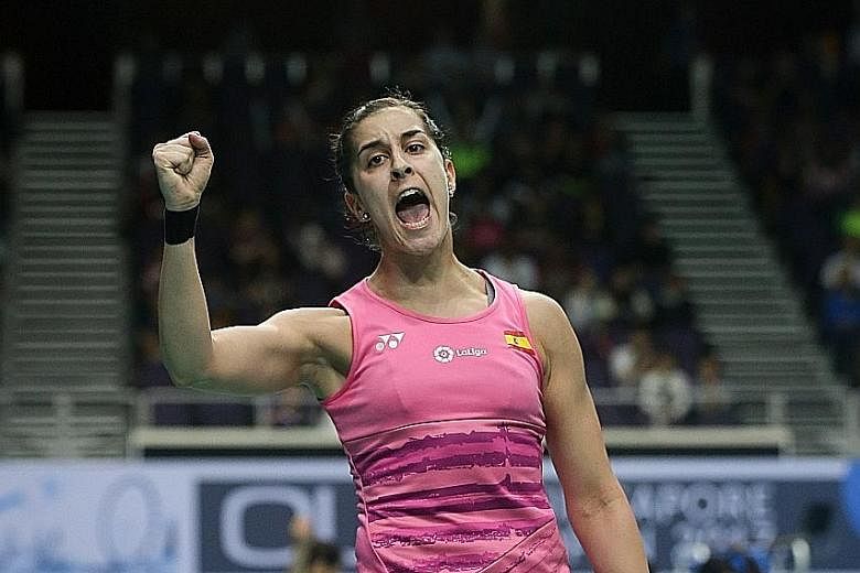 Spain's Carolina Marin celebrates winning a point against India's P.V. Sindhu. The reigning Olympic champion never trailed in either game, winning 21-11, 21-15 in 35 minutes.