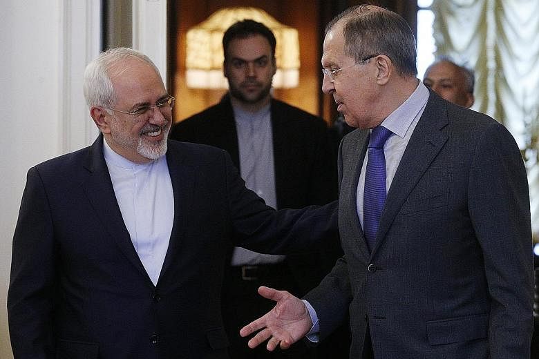 Russian Foreign Minister Sergei Lavrov (right) and his Iranian counterpart, Mr Mohammad Javada Zarif, ahead of talks with Syrian officials in Moscow yesterday on the situation in Syria.