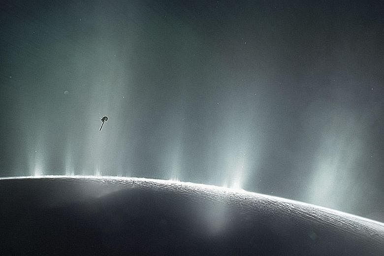 A Nasa photo showing the Cassini spacecraft diving through the plume of Saturn's moon, Enceladus, in 2015.