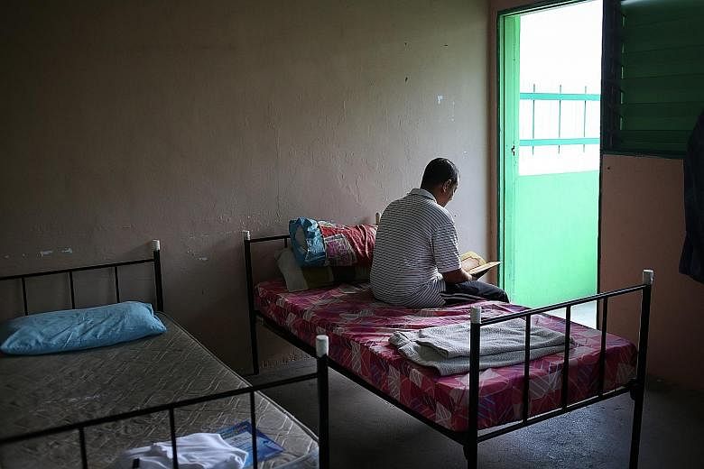 After waking up in the morning, Mr Ahmad, who is a resident at the Pertapis Halfway House, prepares himself for the day ahead. Residents at the Pertapis halfway house can read religious books available in the prayer area of the facility.