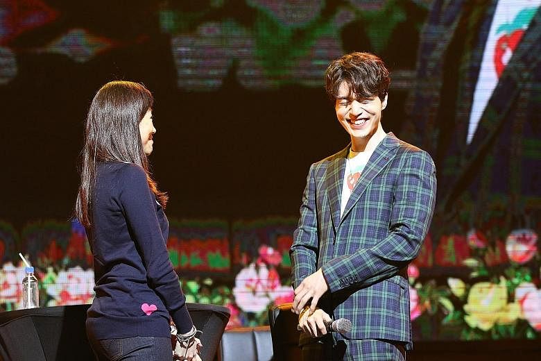 South Korean actor Lee Dong Wook onstage with a fan at Marina Bay Sands last Saturday.