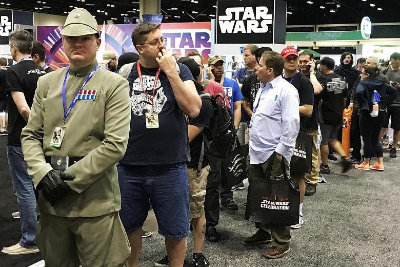 Fans standing in line to grab the new Luke Skywalker figure at the annual Star Wars Celebration, where Walt Disney Co licensees are also selling other exclusive items.