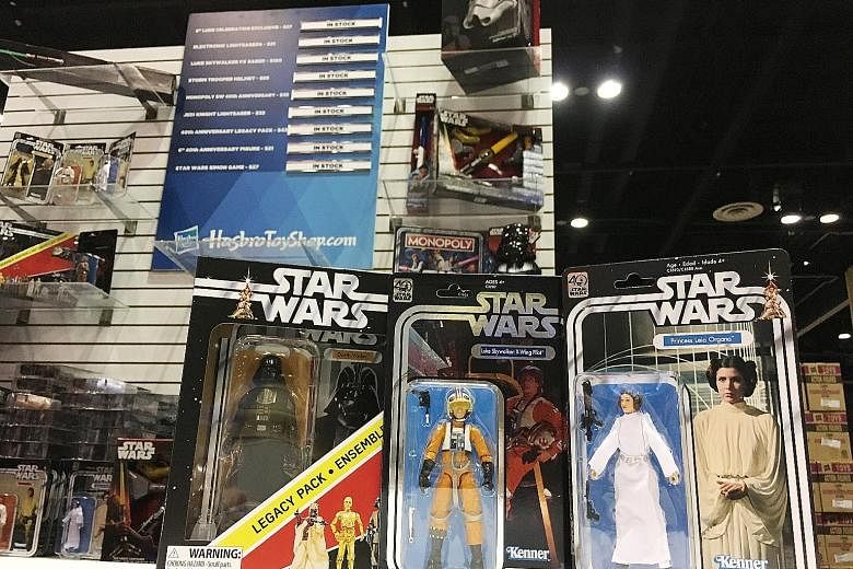 Fans standing in line to grab the new Luke Skywalker figure (above, centre) at the annual Star Wars Celebration, where Walt Disney Co licensees are also selling other exclusive items.