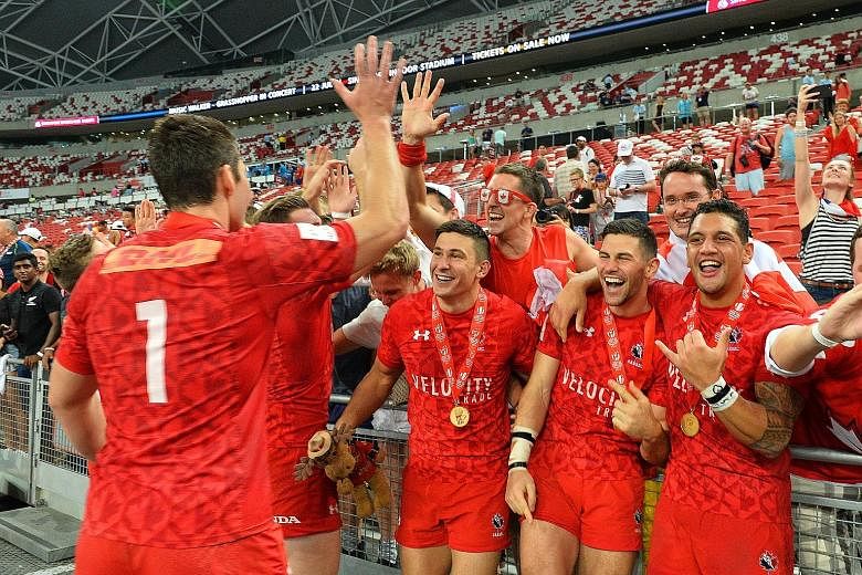 Left: Canada's Lucas Hammond evades the American defence to score the winning try in the Cup final of the HSBC Singapore Rugby Sevens at the National Stadium. Below: Before this momentous win, the Canadians came closest in 2014, when they lost the Cu