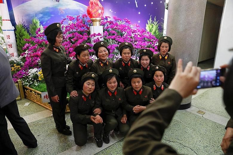 Soldiers at a flower exhibition in Pyongyang yesterday, held as part of festivities to mark the 105th birth anniversary of North Korea's founder Kim Il Sung. Pyongyang is set to celebrate another anniversary - the founding of its army on April 25 - a