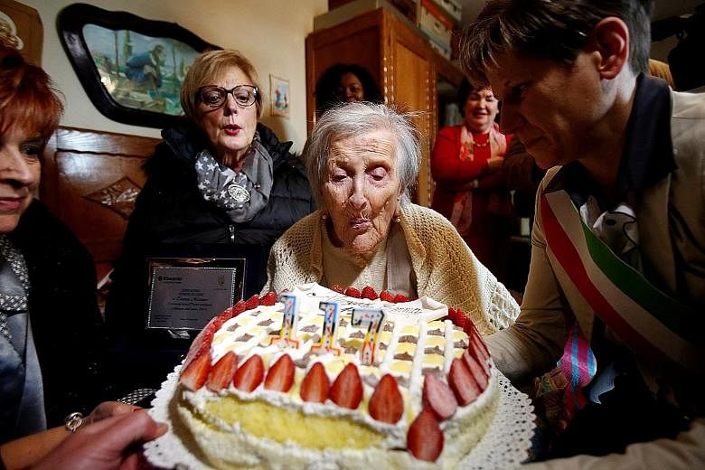 Ms Emma Morano blowing out the candles during her 117th birthday last November. She attributed her longevity to her diet, saying she ate two eggs a day and cookies - not much, as she had no teeth.